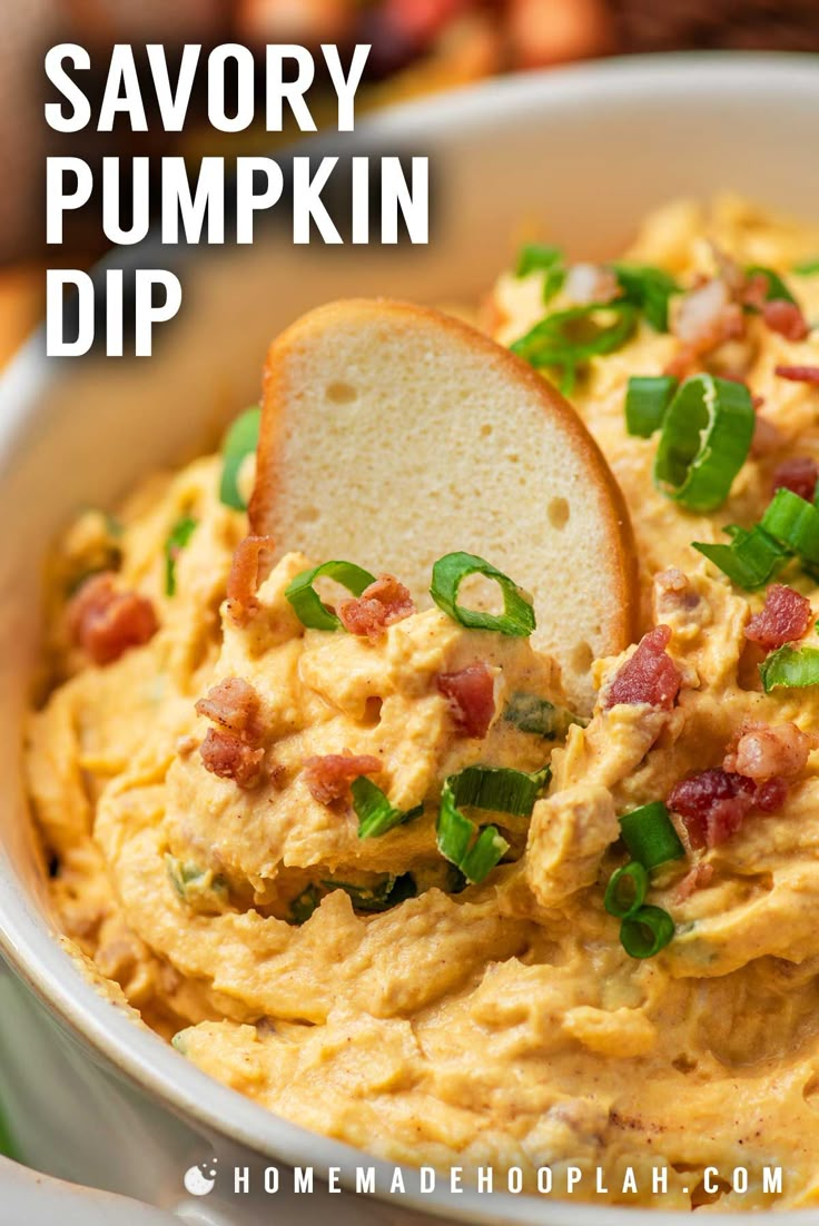 a bowl full of savory pumpkin dip with a piece of bread sticking out of it