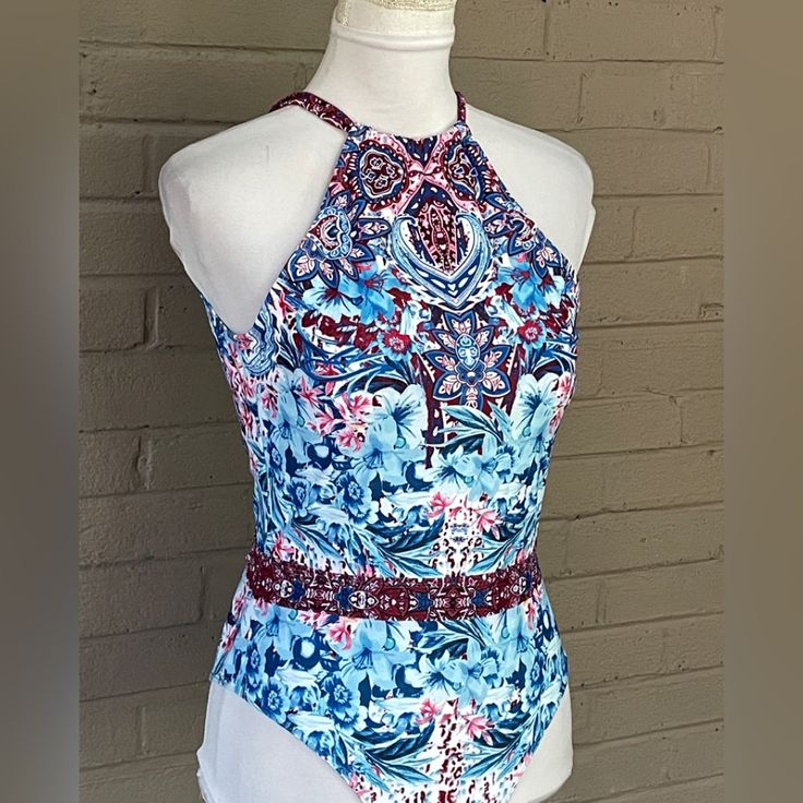 Unique Floral Print In Shades Of Blue , Red And White High Neckline Back Tie Neck Fully Lined Soft Moulded Cups Blue Floral Print Stretch Bodysuit, Blue Stretch Bodysuit With Floral Print, Blue Sleeveless Printed Bodysuit, Blue Printed Sleeveless Bodysuit, Print Swimsuit, Tie Neck, High Neckline, Shades Of Blue, Neck Tie