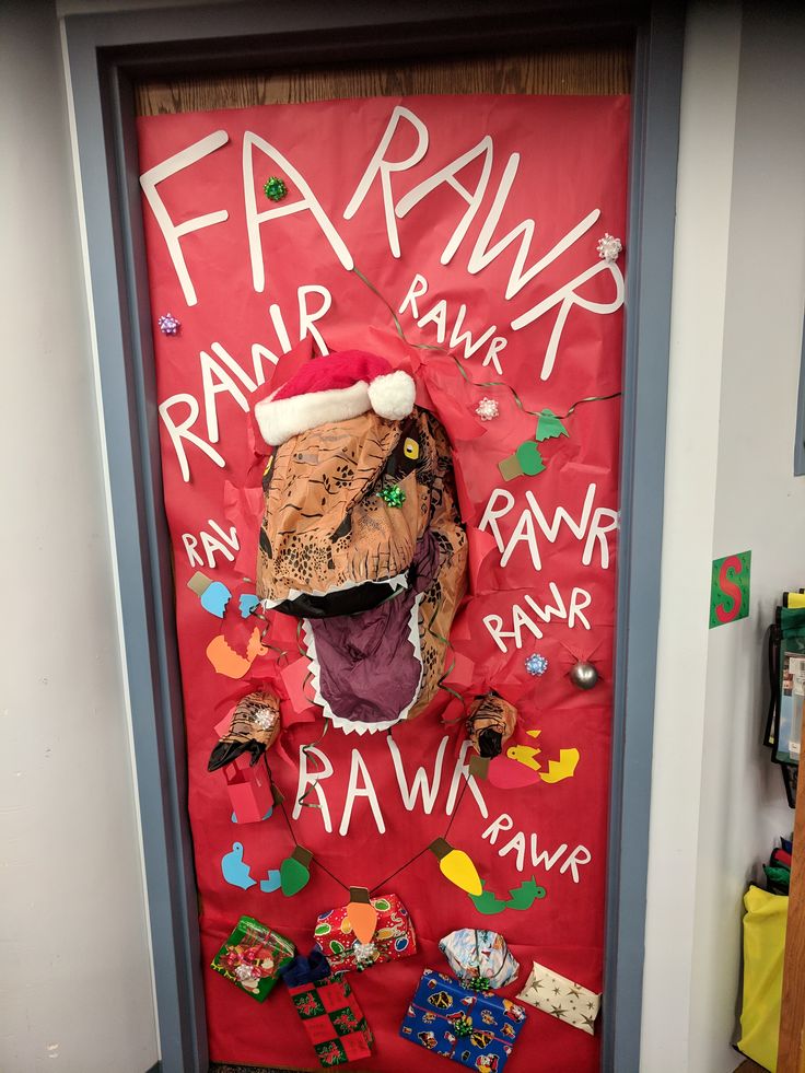 a door decorated for christmas with an animal's head and name written on it