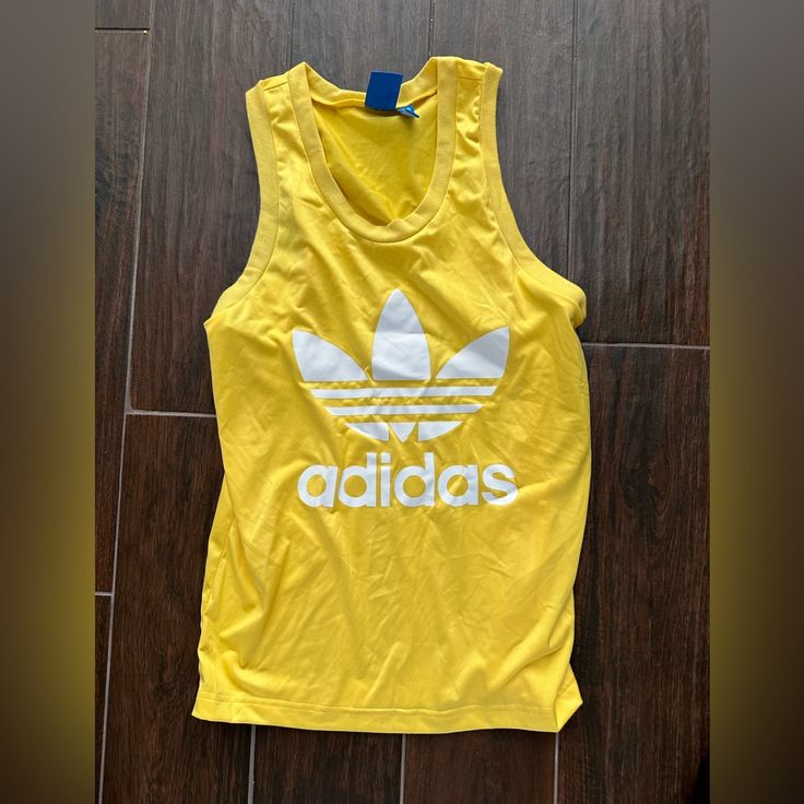 Adidas Cut Off T Shirt Bright Yellow With Adidas Logo Size Small- Good Condition Casual Yellow Tank Top With Graphic Print, Adidas Casual Tank Top For Sports, Sporty Yellow Tops With Graphic Print, Sporty Yellow Tops For Summer, Adidas Tank Top For Summer Sports, Adidas Casual Summer Tank Top, Adidas Sporty Summer Tank Top, Yellow Sports Tank Top For Summer, Casual Adidas Summer Tank Top