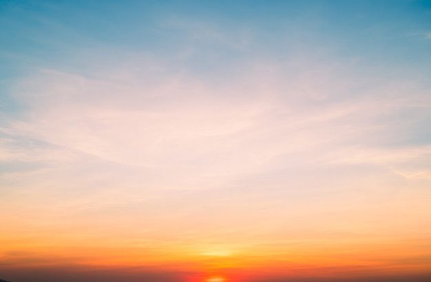 the sun is setting over the ocean with boats in the water