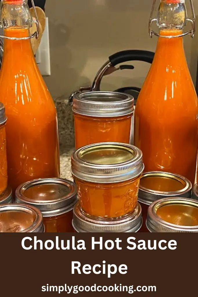 several jars filled with hot sauce sitting on top of a counter