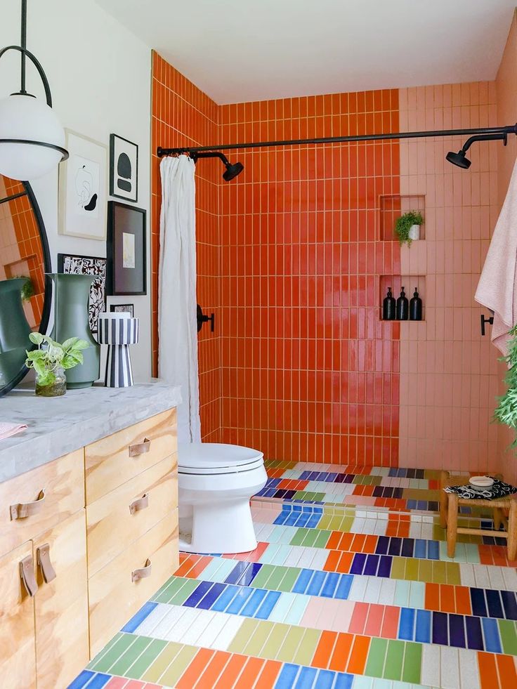 a bathroom with an orange tiled floor and walls