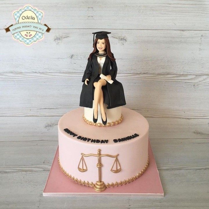 a cake that has a woman sitting on top of it with a scale in front of her