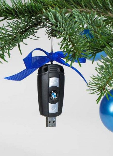 a christmas ornament hanging from a tree with a car key attached to it