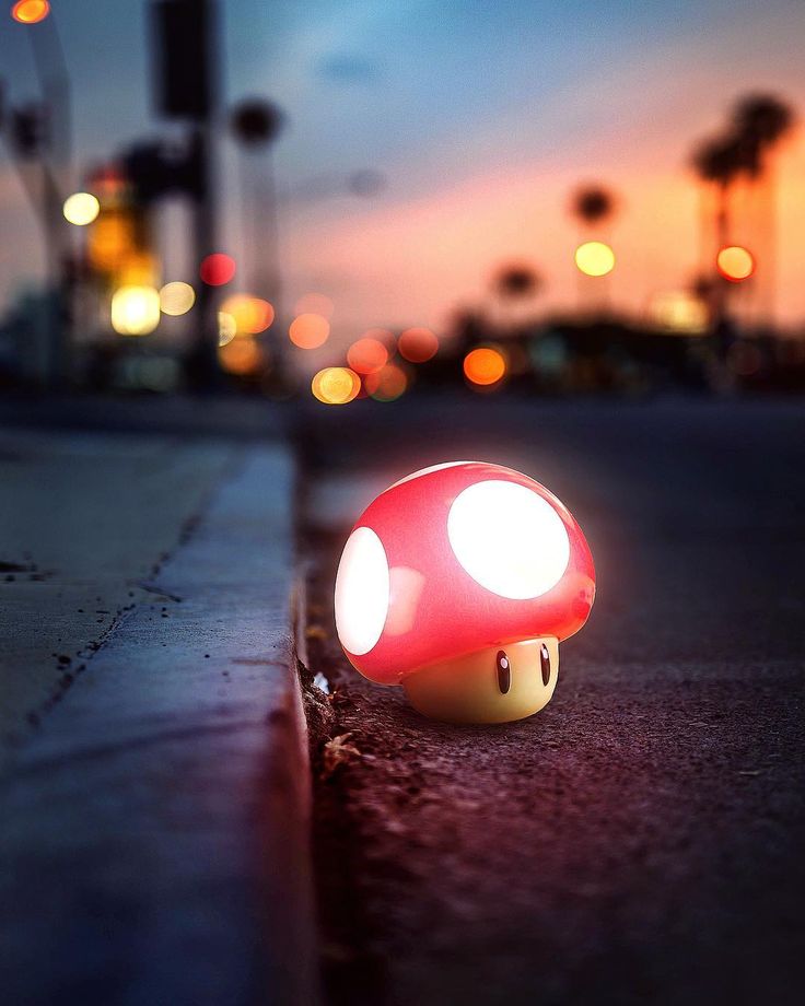 a red mushroom light sitting on the side of a road