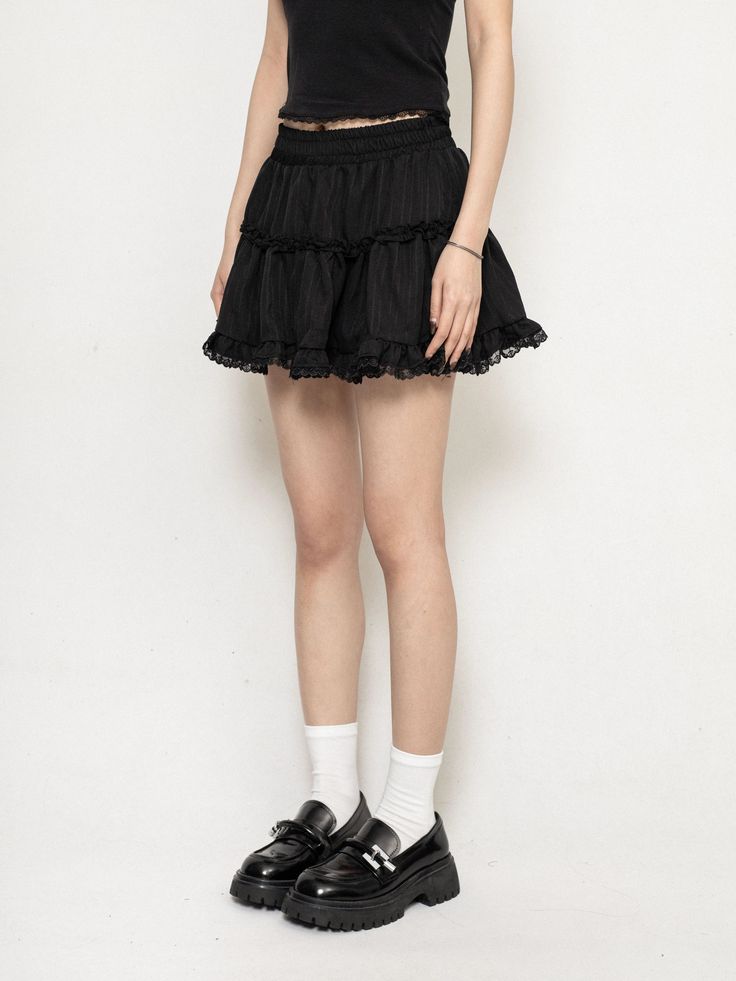 Exude confidence with every step in this moody Layered Ruffle Mini Skirt with Lace Trim, where edgy meets delicacy in perfect harmony. Crafted from soft, breathable cotton, this skirt is as comfortable as it is stylish. The intricate lace trim and cascading ruffled layers generate a uniquely textured silhouette that's both flirty and sophisticated. Its high-waisted design ensures a flattering fit, while the A-line cut offers ease of movement, making it an ideal choice for those spontaneous outin Edgy Pleated Skort For Summer, Chic Pleated Skirt With Ruffles For Summer, Chic Summer Pleated Skirt With Ruffles, Stretch Cotton Ruffled Skirt, Edgy Summer Skort With Lined Skirt, Feminine Layered Hem Tiered Skirt, Chic Ruffled Pleated Flared Skirt, Edgy Pleated Summer Skirt, Chic Pleated Flared Skirt With Ruffles