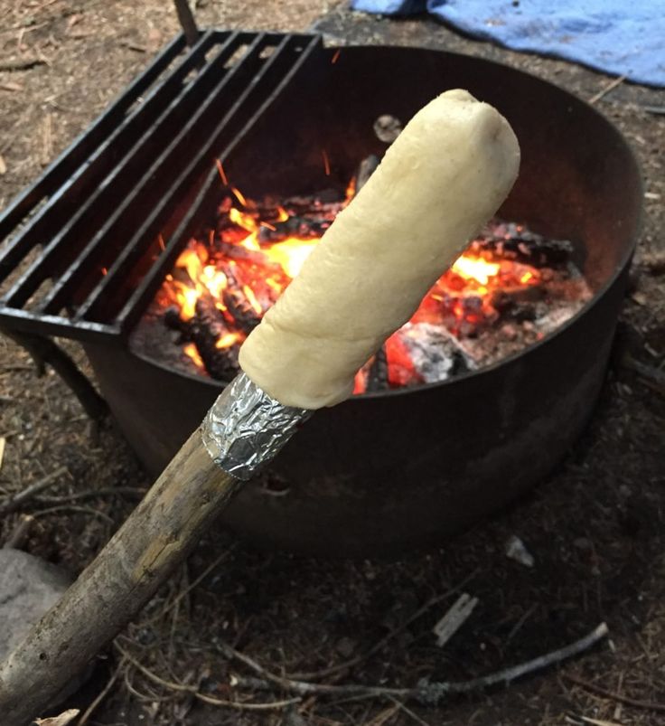 a hot dog is being cooked over an open fire