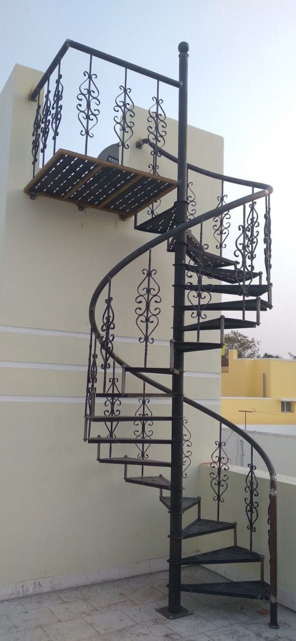 a spiral staircase on the side of a building