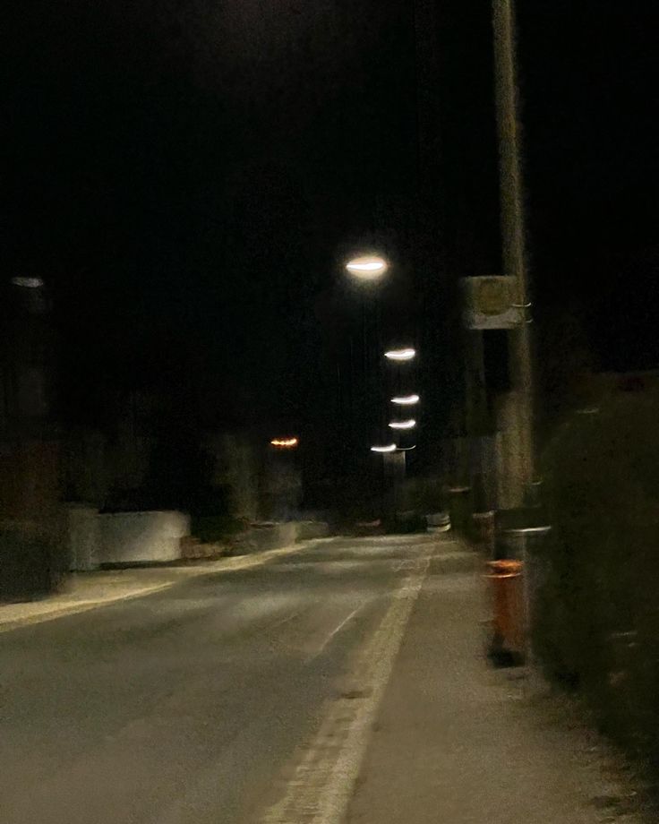 an empty street at night with no cars on it