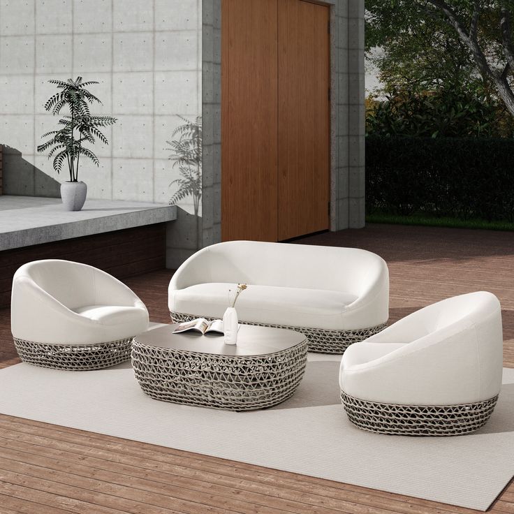 an outdoor living room with white furniture and wood flooring