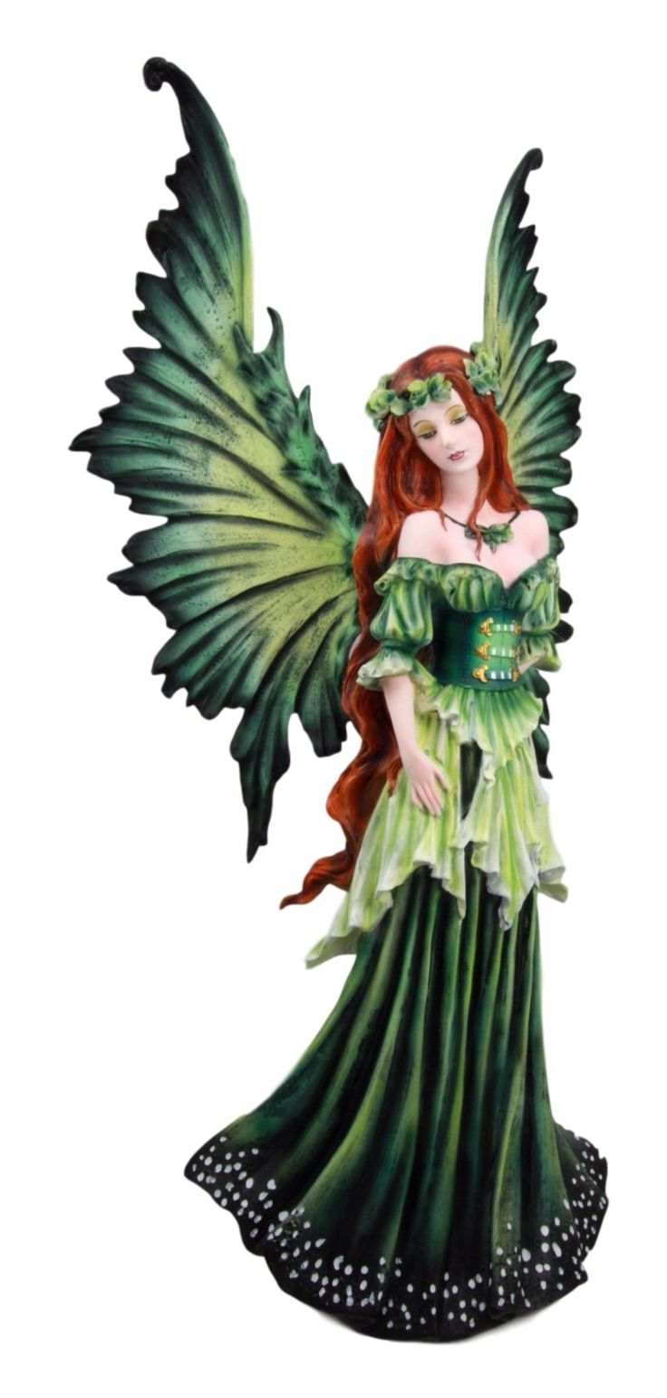 a green fairy figurine with wings