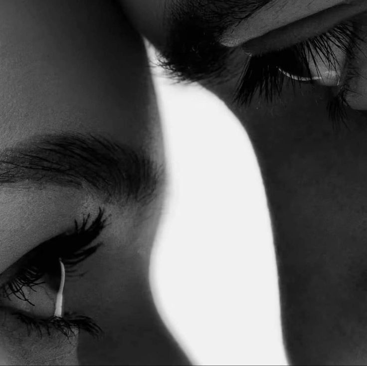 a man and woman are looking at each other's eyes with one eye closed