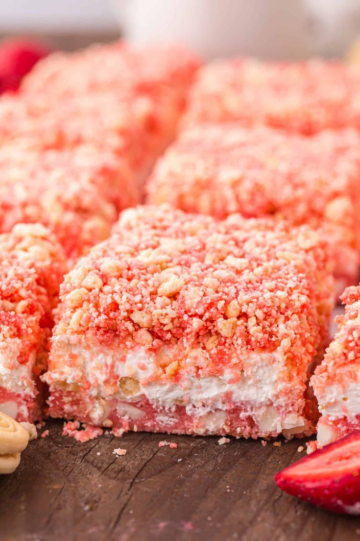 strawberry crumb bars cut into squares on a cutting board