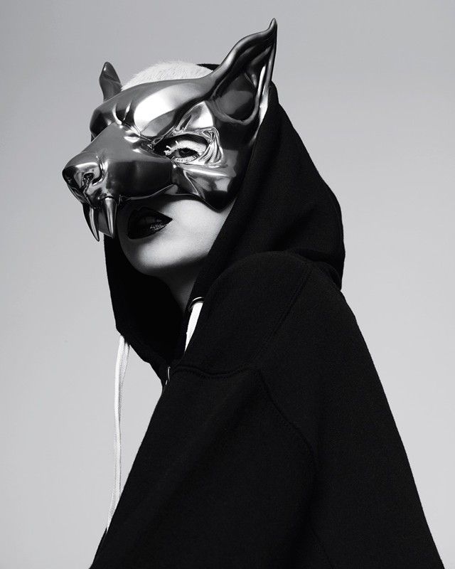 a person wearing a cat mask and black hoodie