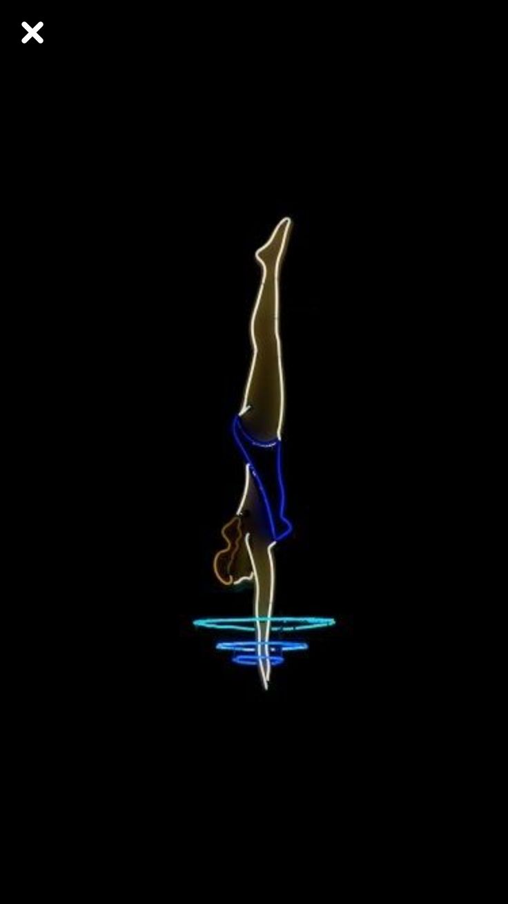 a person doing a handstand in the dark