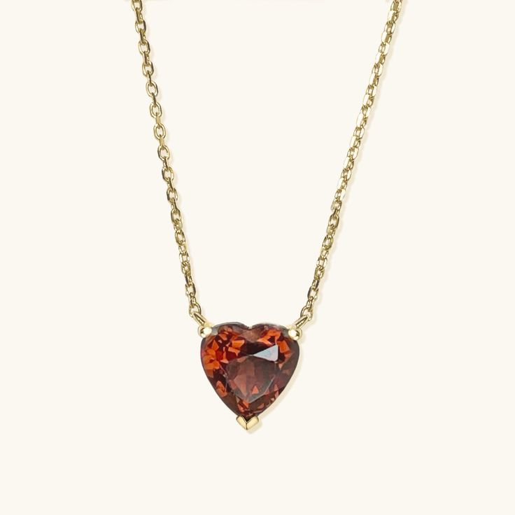 Simple, elegant, and timeless! Presenting our heart-shaped natural garnet necklace handcrafted in 9K solid gold. This style is offered in a choice of other gemstones as well. Can be paired with our Gold Heart Shape Garnet Studs. Ships within 3 business days. - Stone size: 5mm(0.5ct) or 7mm(1ct) - Stone info: natural garnet - Chain length: adjustable 16+2" - Made in 9 karat gold. - Stamp with 9K. Classic Gemstone Necklaces For Valentine's Day, Classic Gemstone Necklace For Valentine's Day, Formal Heart Cut Birthstone Necklace, Classic Heart-shaped Birthstone Necklace, Heart Pendant Necklace With Gemstone For Formal Occasions, Formal Heart Necklace With Birthstone, Formal Heart-shaped Birthstone Necklace, Formal Heart Shaped Birthstone Necklace, Fine Jewelry Heart Necklace With Birthstone For Formal Occasions