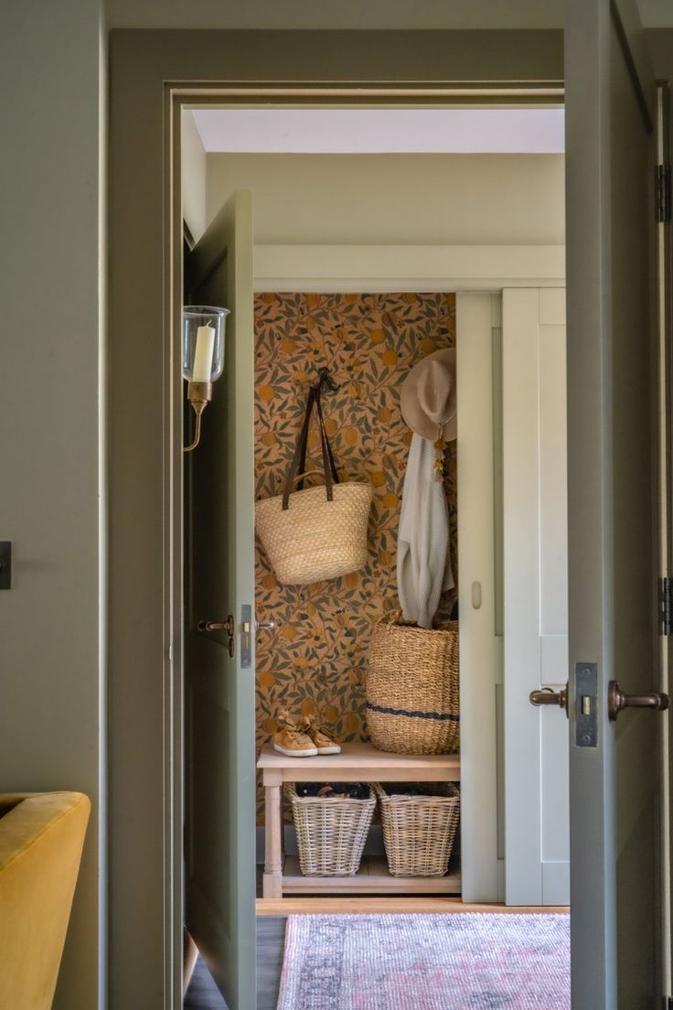 an entry way with baskets on the wall