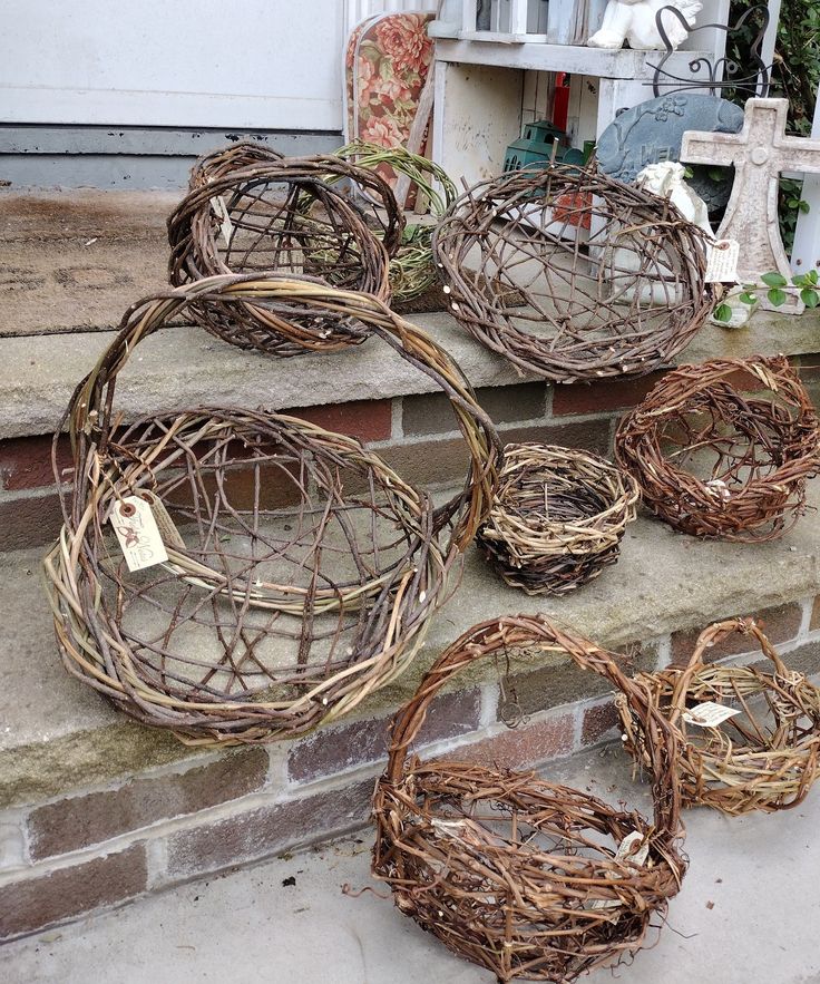 wicker baskets are sitting on the steps in front of a house, ready to be used as planters