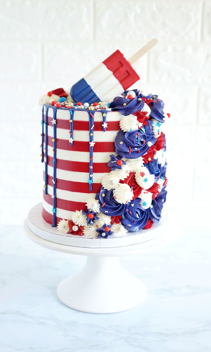 a red, white and blue cake with an american flag design on it's side