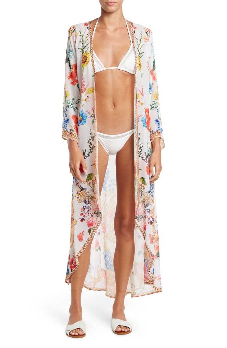 Vivacious floral printing blooms across a lightweight, duster cover-up featuring dramatic kimono sleeves for an ultra chic, post-swim look. 52" length Open front Kimono sleeves 100% polyester Dry clean Imported Model stats: 5'10" height, 32" bust, 25" waist, 36" hip. Model is wearing size One Size. Bohemian Spring Brunch Cover-up, Floral Print Open Front Cover-up For Vacation, Chic Unlined Spring Cover-up, Chic Spring Unlined Cover-up, Long Beachwear Cover-up For Spring, Flowy Beachwear Cover-up For Spring, Flowy Spring Beachwear Cover-up, Summer Floral Print Open Front Cover-up, Summer Floral Open Front Cover-up