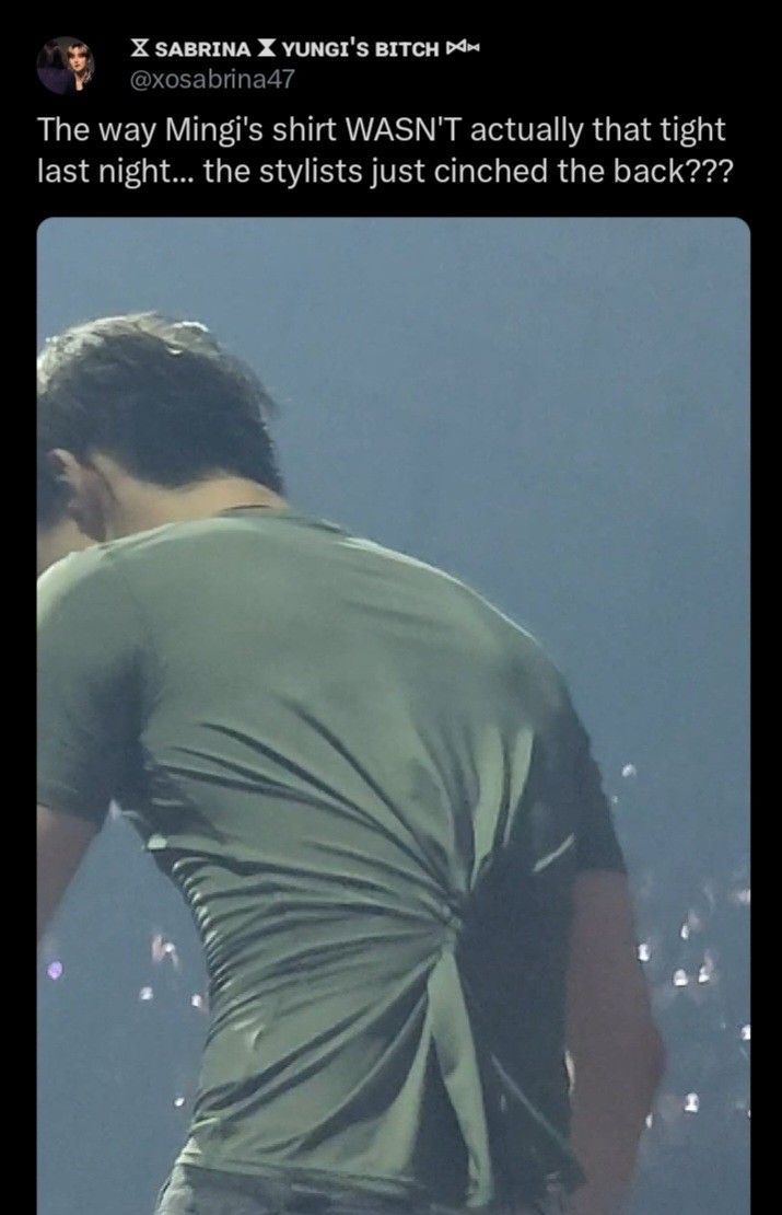 the back of a man's green shirt on stage