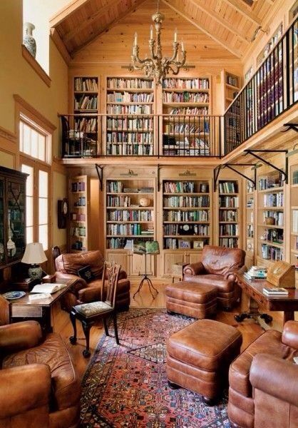 a living room filled with lots of brown furniture and bookshelves full of books