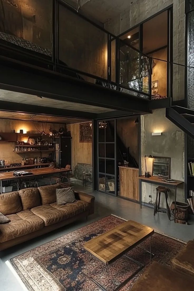 a living room filled with furniture next to a stair case in a loft style home