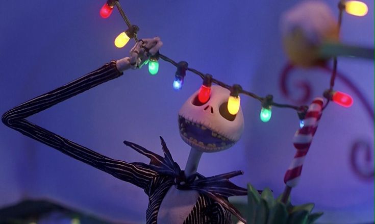 a jack - o'- lantern decoration with christmas lights and candy canes on it