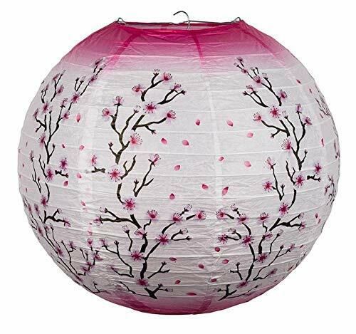 a pink and white paper lantern with branches painted on it