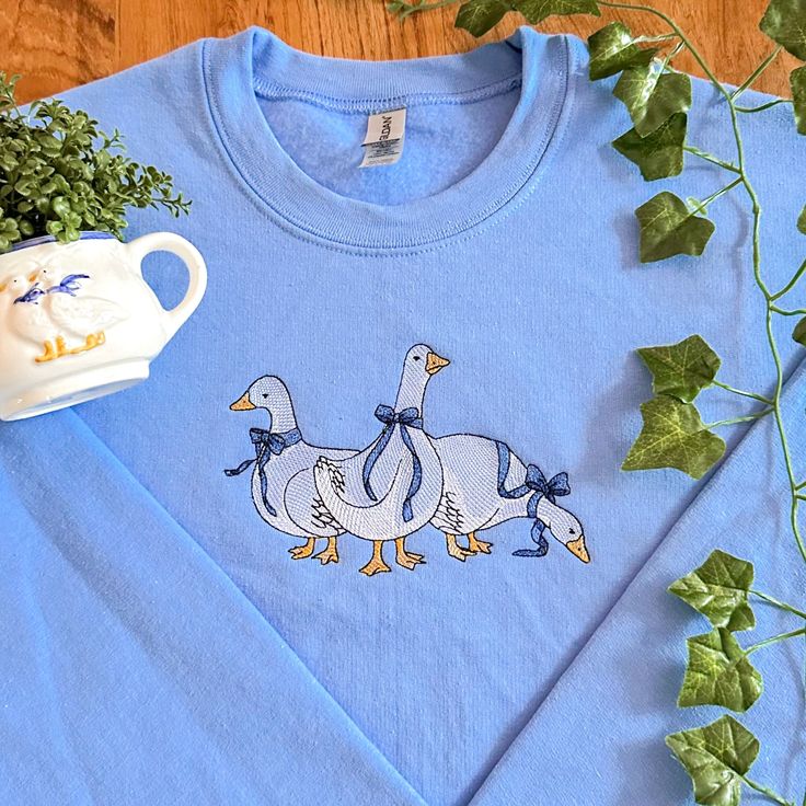 Dainty Geese Embroidered Sweatshirt - Etsy Blue Sweater With Embroidered Text For Fall, Blue Embroidered Text Sweater For Fall, Blue Cotton Sweater With Embroidered Logo, Spring Cotton Sweater With Embroidered Logo, Crew Cotton Top With Machine Embroidery, Cotton Crew Top With Machine Embroidery, Custom Embroidered Cotton Crew Neck Sweater, Cotton Crew Neck Sweater With Custom Embroidery, Cotton Crew Neck Top With Machine Embroidery