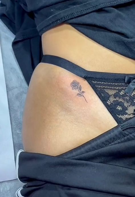 a woman's stomach with a tattoo on her lower back and the bottom part of her panties