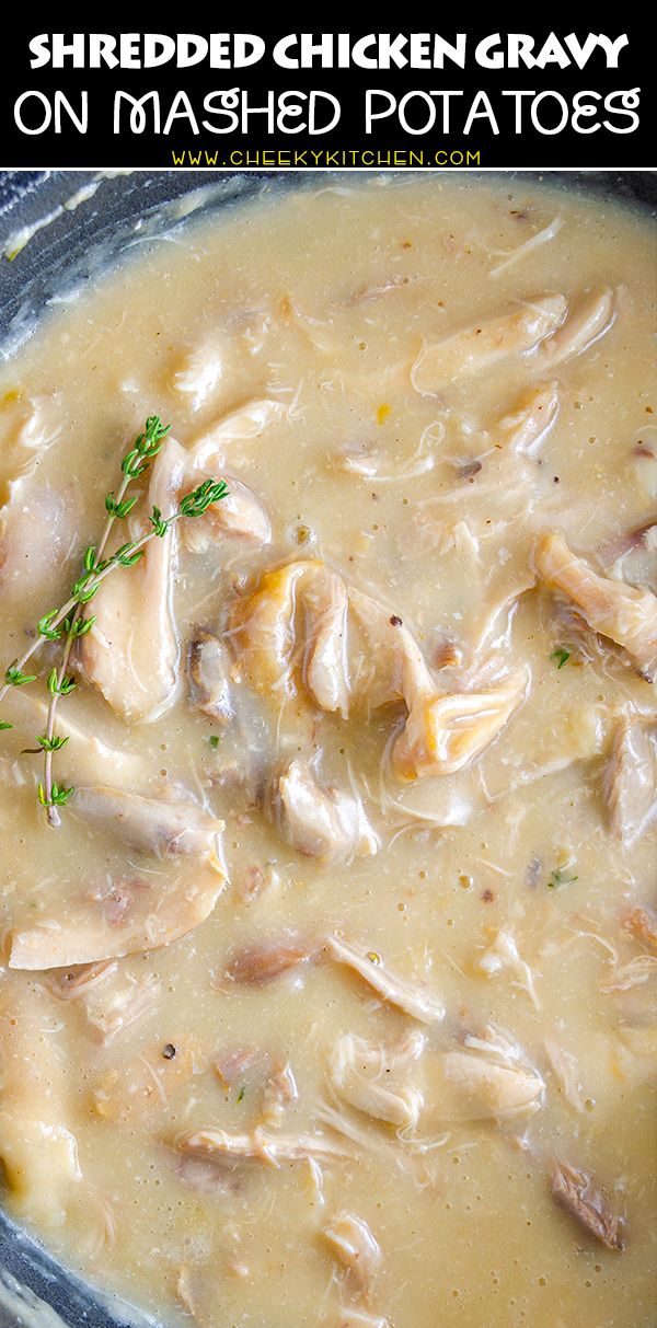 a bowl filled with chicken and gravy on top of a table