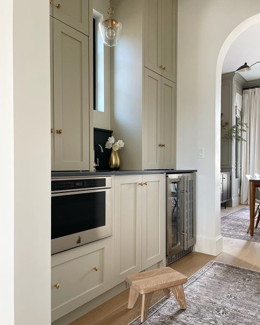 a kitchen with an oven, sink and dining table in it's center area