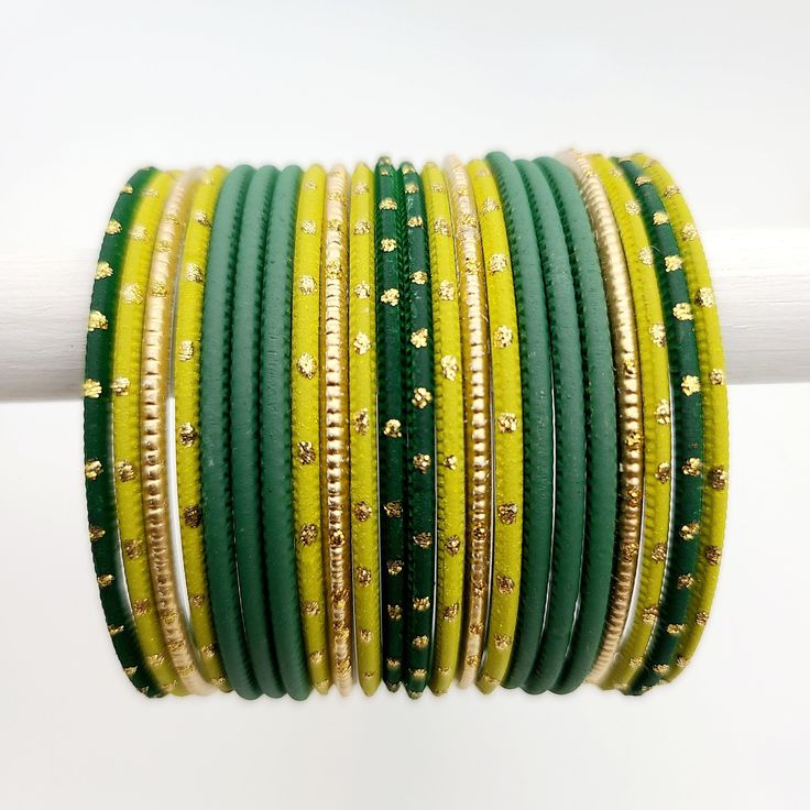 Beautifully designed bangles for any occasion. South asian bracelets come in a variety of styles, colors, and finishes. We at Banglez take creating the perfect bangle set for you to another level! You could say helping you find your favorite stack of bangles as one of our greatest missions. This bangle set was curated in house by one of our talented team members. We hope you love them as much as we do! Green Stackable Bangle Beaded Bracelets, Green Stackable Beaded Bangle Bracelets, Festive Handmade Yellow Bracelets, Green Stackable Bangle Bracelets, Handmade Adjustable Bollywood Bangle, Festival Stackable Bangles, Green Adjustable Cuff Bracelet For Wedding, Adjustable Green Cuff Bracelet For Wedding, Festival Stackable Bangle