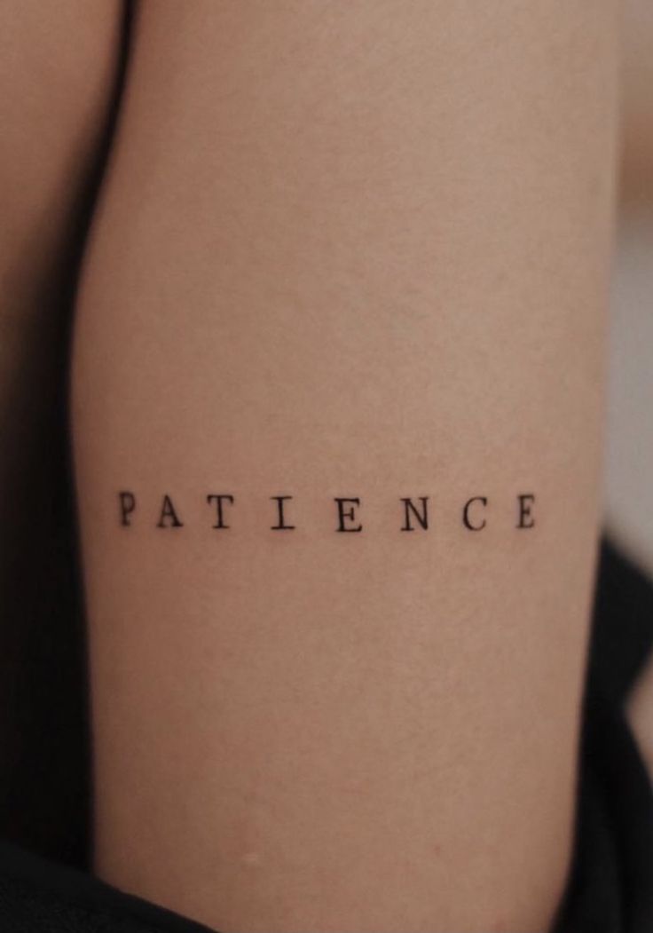 a woman's leg with the word patience written on it in cursive font