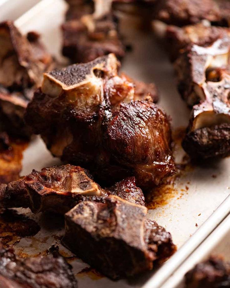 the meat is being cooked on the tray ready to be cut into bite sized pieces