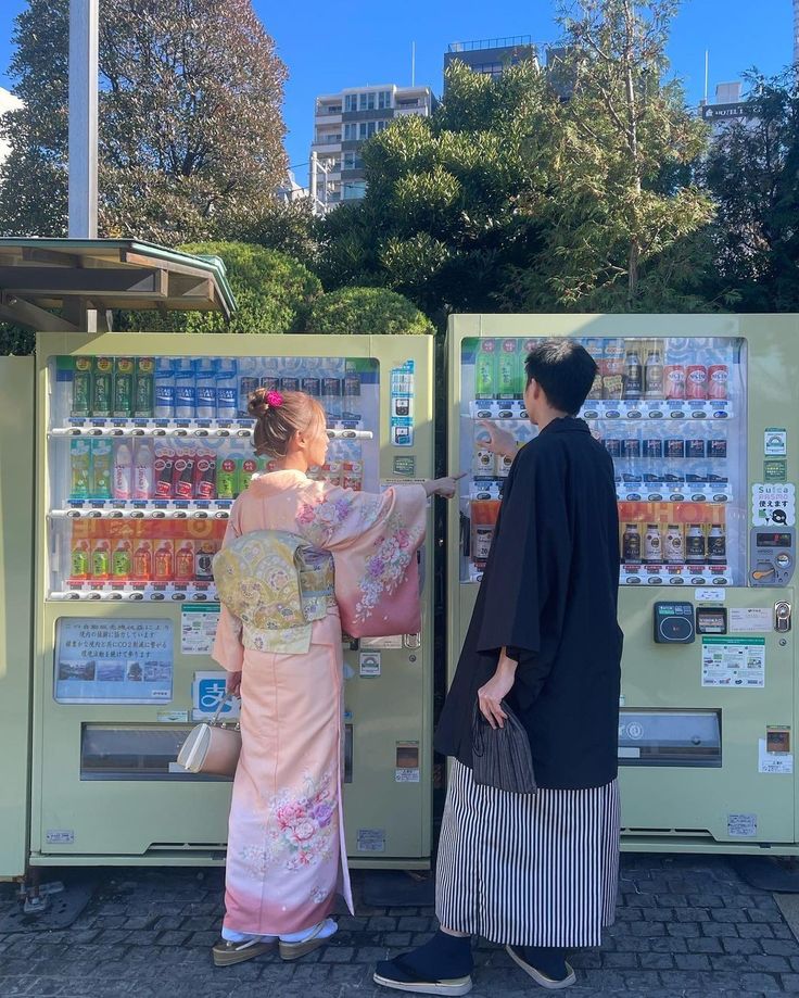 two women are standing in front of a vending machine