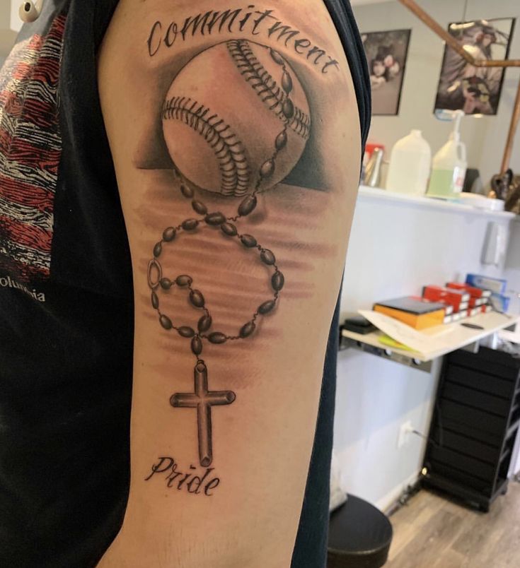 a man with a baseball and rosary tattoo on his arm