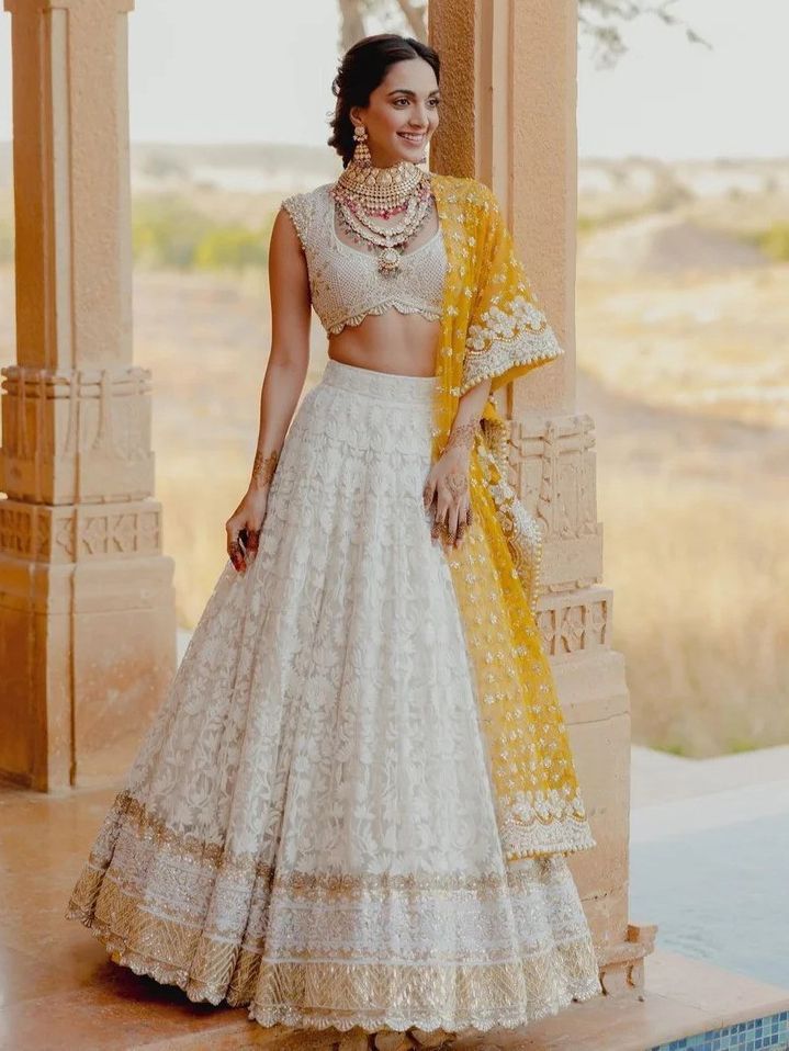 The georgette material drapes luxuriously, adorned with intricate embroidered patterns and delicate sequin work. The semi-stitched lehenga, with a circumference of up to 42 inches, offers a perfect fit, making it ideal for weddings, engagements, and special occasions.
Complementing the lehenga is a georgette choli, mirroring the exquisite detailing with embroidered patterns and sequin work. The choli comes fully unstitched, allowing for customization to achieve a personalized fit and style.
Comp Lehenga White, Manish Malhotra Lehenga, White Lehenga Choli, Haldi Dress, Chikankari Lehenga, Lehenga Choli Designs, Haldi Outfits, Haldi Outfit, White Lehenga