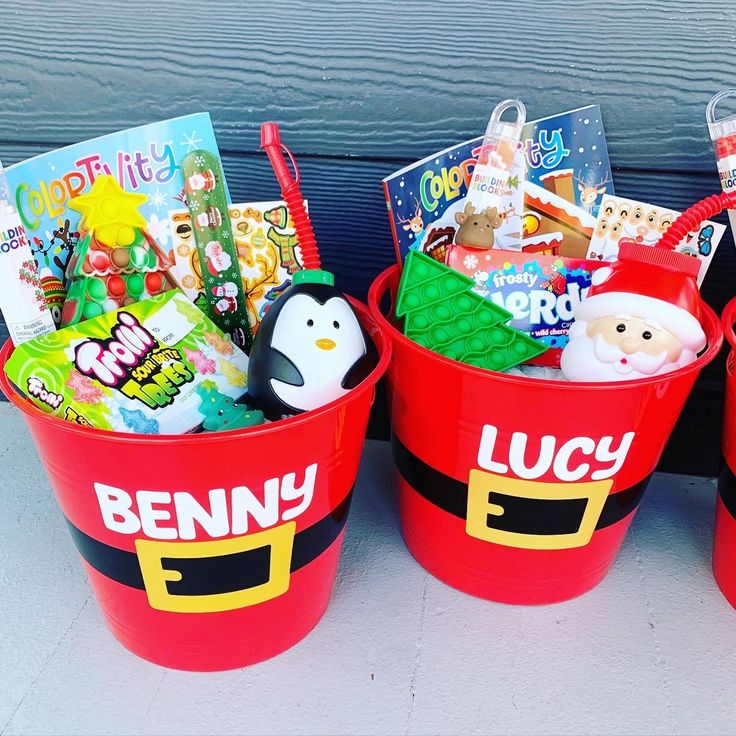 three red buckets filled with toys and books