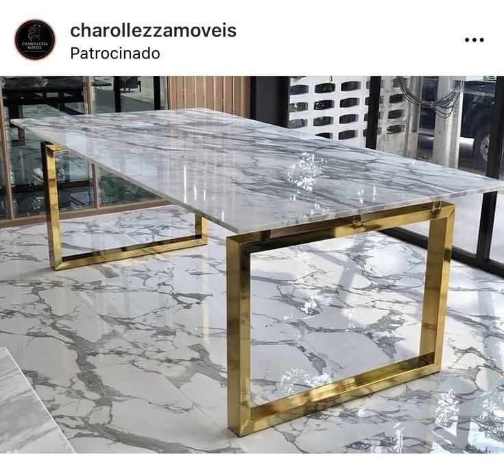 a marble table with gold legs in a room