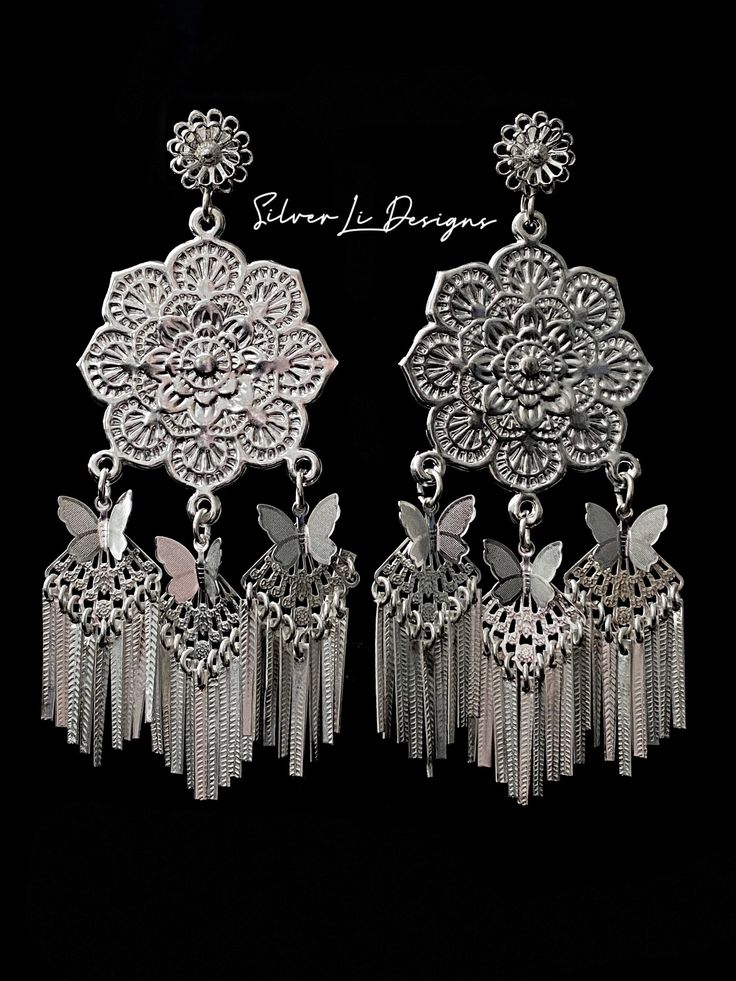 "Beautiful handcrafted \"money 2\" (fine silver plated) Hmong-style earrings To avoid oxidation, please avoid getting jewelry wet and avoid spraying perfume onto jewelry. May be cleaned with silver cleaning wipes." Traditional Silver Dangle Clip-on Earrings, Silver Hypoallergenic Drop Plug Earrings, Hypoallergenic Silver Drop Earrings, Vintage Silver Nickel-free Plug Earrings, Vintage Nickel-free Silver Plug Earrings, Nickel-free Silver Plug Earrings For Parties, Vintage Nickel-free Silver Chandelier Earrings, Vintage Silver Round Chandelier Earrings, Silver Sterling Party Plug Earrings