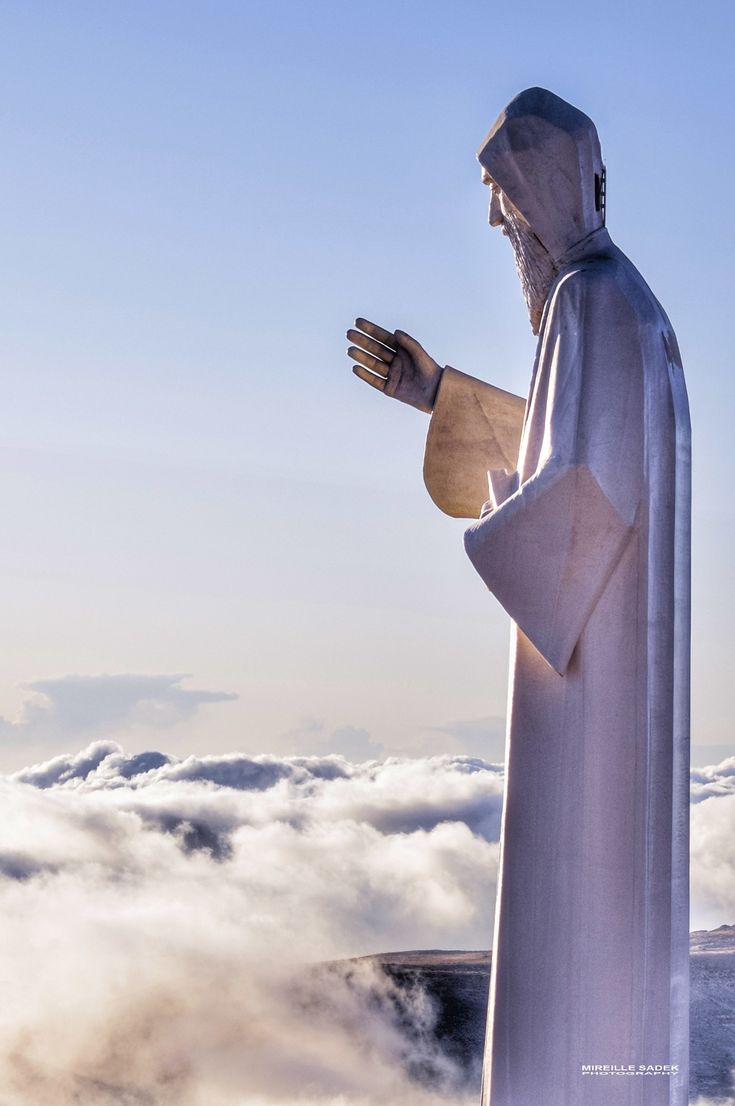 there is a statue that looks like jesus in the clouds