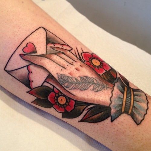 a woman's arm with an arrow and flowers on it