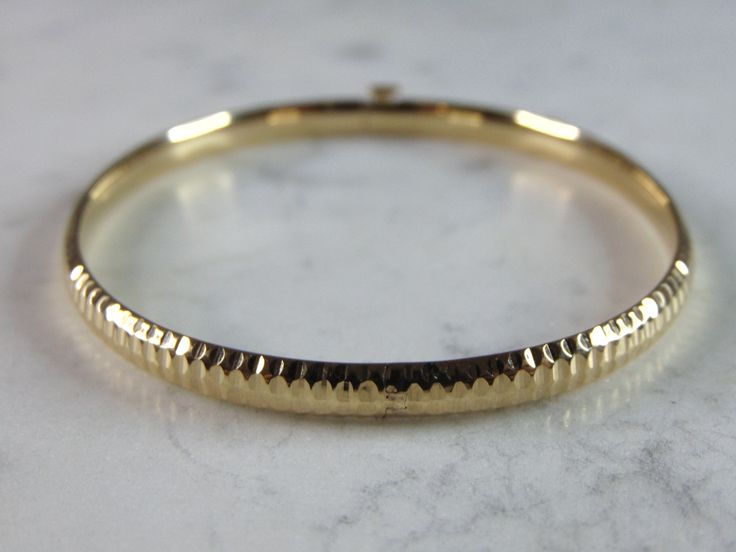 "A WOMENS VINTAGE ESTATE 14K YELLOW GOLD BANGLE BRACELET. THE TOTAL WEIGHT IS 6g, AND HAS AN INNER CIRCUMFERENCE 0F 7\" AND IS 1/4\" WIDE. ANY QUESTIONS PLEASE DONT HESITATE TO ASK. BE SURE TO CHECK OUT SOME OF OUR OTHER GREAT ITEMS UP FOR SALE. THANK YOU. IF THERE ARE ANY ISSUES PLEASE CONTACT US, WE'RE ALWAYS HAPPY TO TRY TO HELP YOU OUT AS BEST AS WE CAN." Vintage Yellow Gold Bangle Stamped 14k, Hallmarked Round Gold Bracelet, Vintage Round Diamond Cut Bracelet, 14k Gold Round Chain Bracelet, Hallmarked 14k Gold Bracelet, Heirloom 14k Gold Round Bracelets, 14k Gold Round Diamond Cut Bracelets, Heirloom 14k Gold Bracelets, Heirloom 14k Gold Round Bracelet