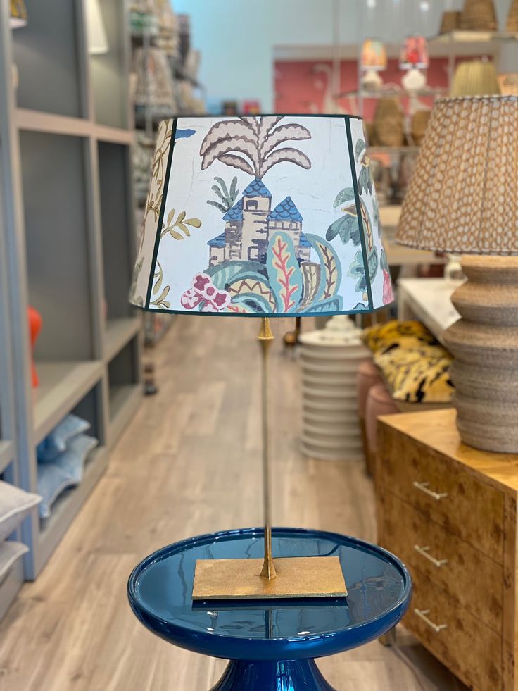 a blue table with a lamp on it in a store