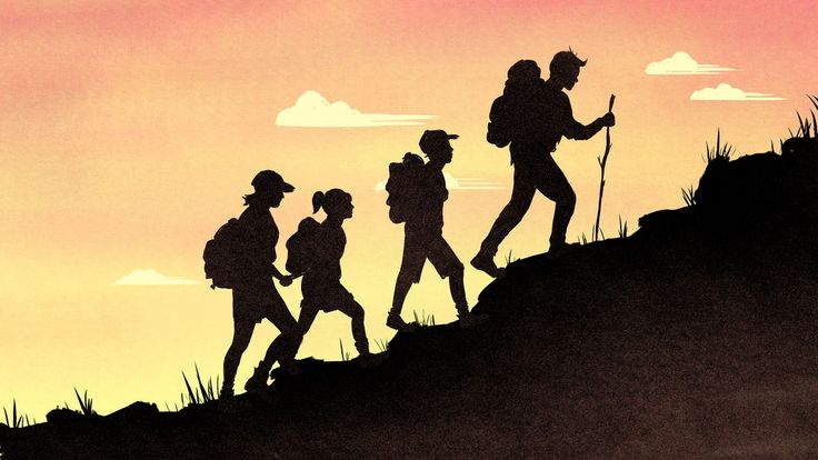 a group of hikers walking up a hill in the sunset with backpacks on