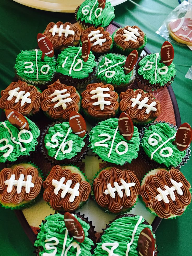 cupcakes with green frosting decorated like footballs and the number twenty six