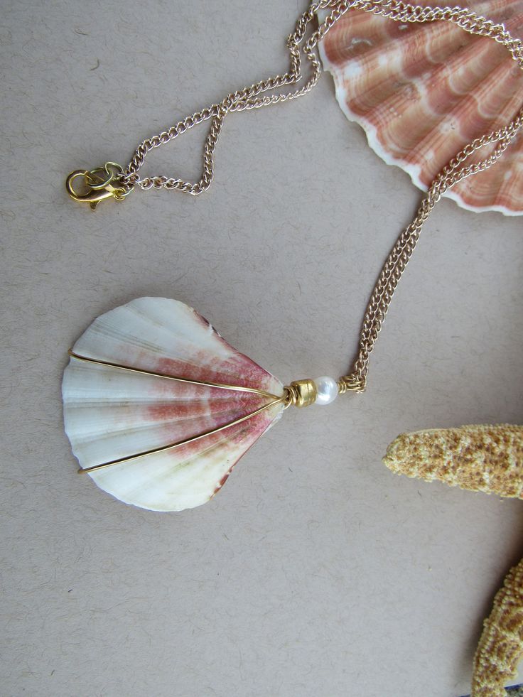 a seashell and starfish on a chain